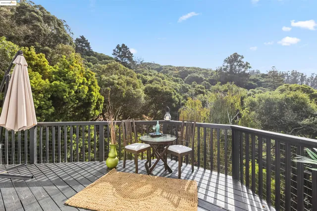 a view of a balcony with chair and wooden floor