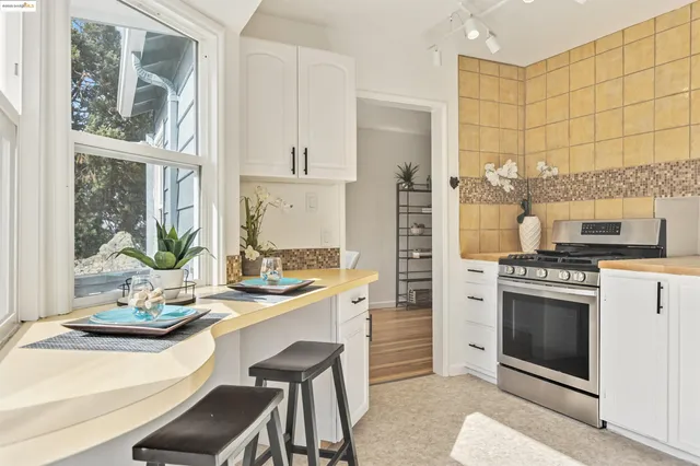 a kitchen with a stove a sink and cabinets