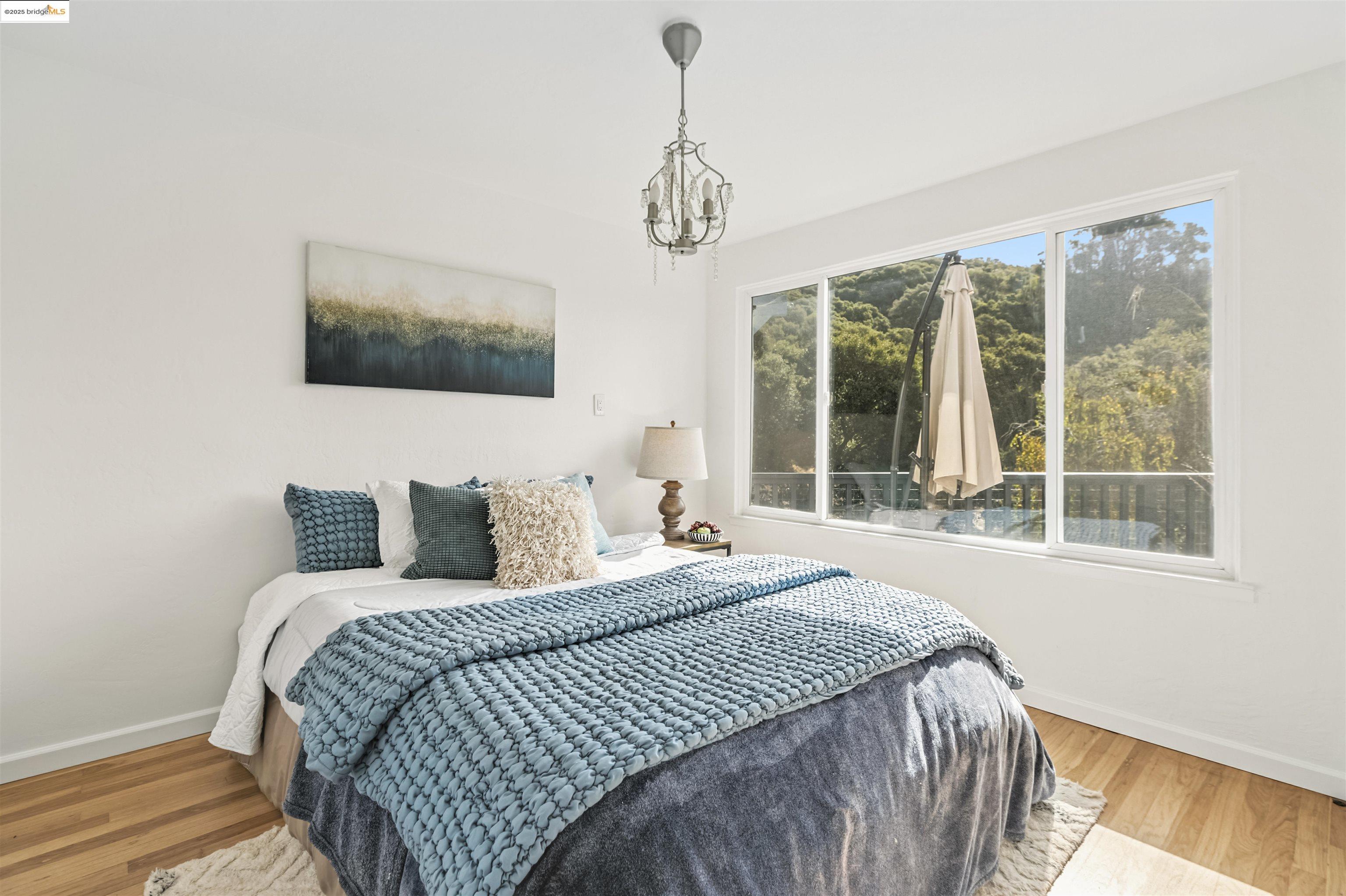 7318 Gladys Avenue El Cerrito, CA 94530 - Photo 18 of 33 a bedroom with bed tv and window