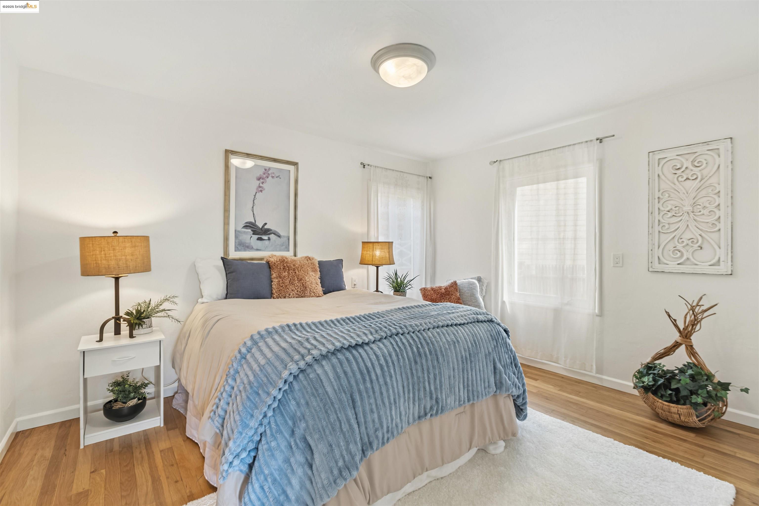 7318 Gladys Avenue El Cerrito, CA 94530 - Photo 21 of 33 a bedroom with a bed and a chandelier