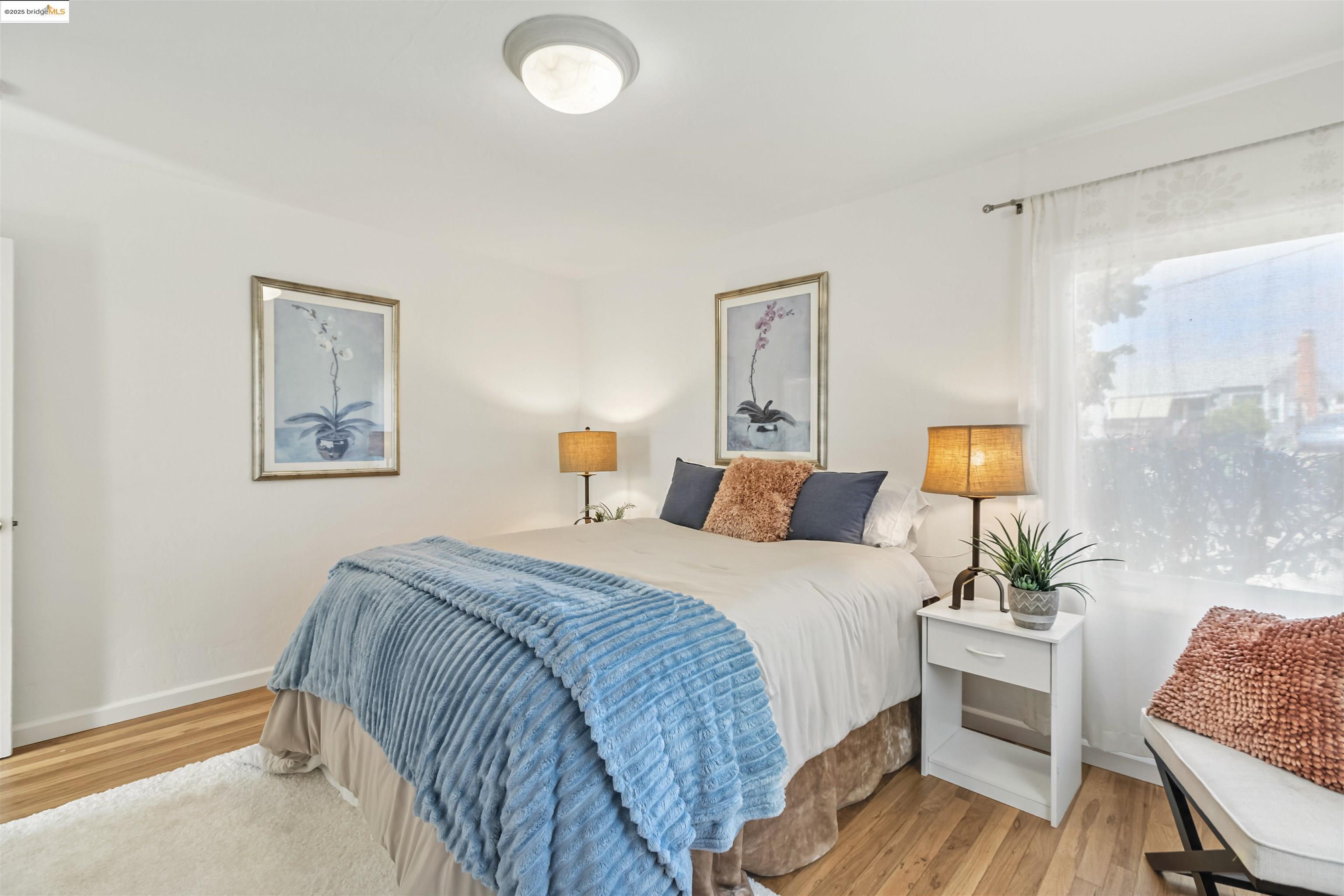 7318 Gladys Avenue El Cerrito, CA 94530 - Photo 22 of 33 a bedroom with a bed and a table chair