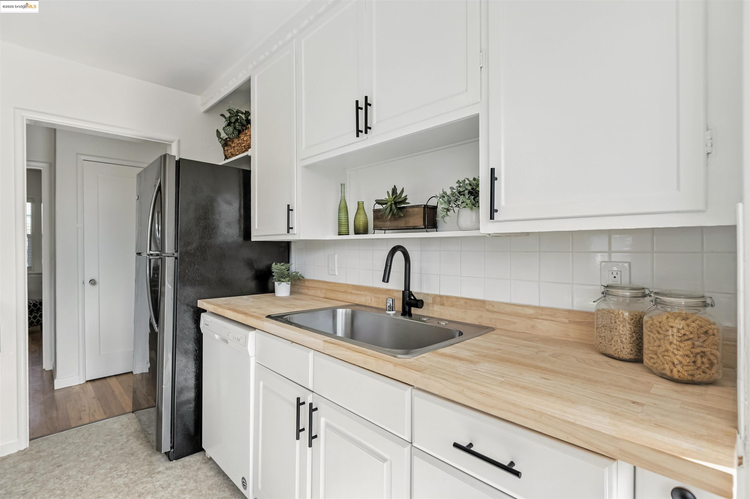 7318 Gladys Avenue El Cerrito, CA 94530 - Photo 9 of 33 a kitchen with stainless steel appliances granite countertop a sink and a refrigerator