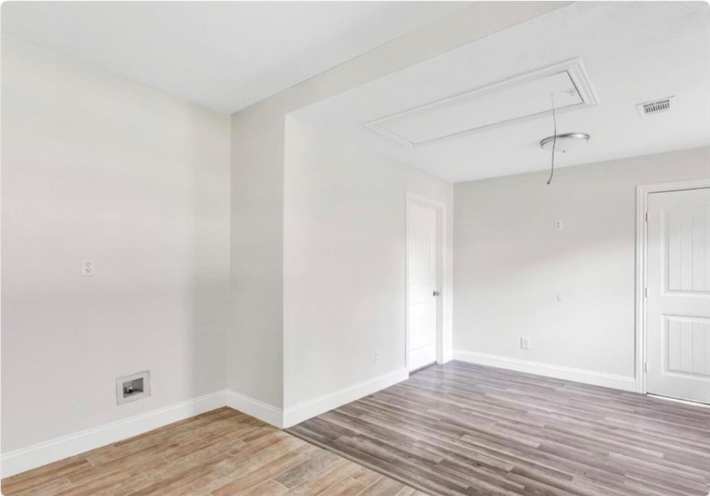 116 Trahan Street Ames, TX 77575 - Photo 11 of 23 a view of an empty room and wooden floor