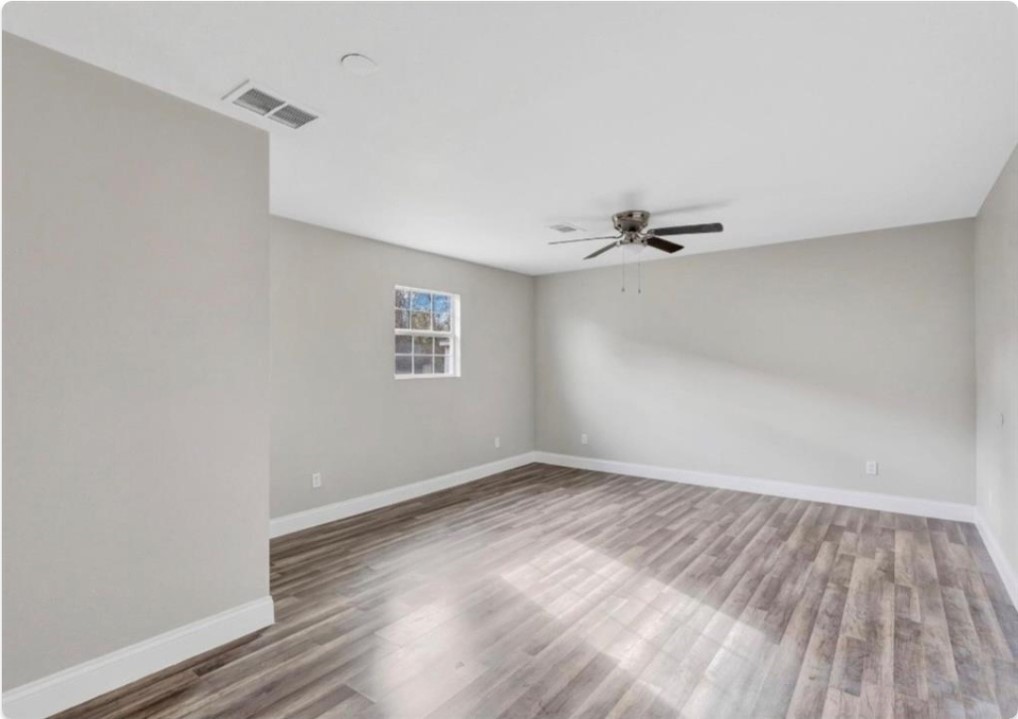 116 Trahan Street Ames, TX 77575 - Photo 15 of 23 a view of a room with wooden floor and white walls