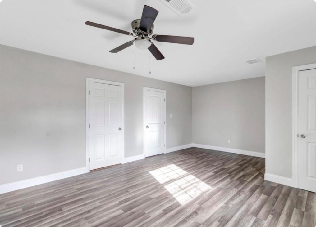 116 Trahan Street Ames, TX 77575 - Photo 16 of 23 a view of empty room with wooden floor
