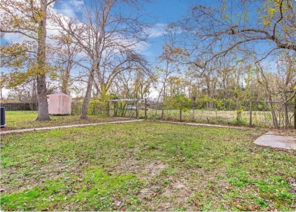 116 Trahan Street Ames, TX 77575 - Photo 22 of 23 a view of backyard with green space