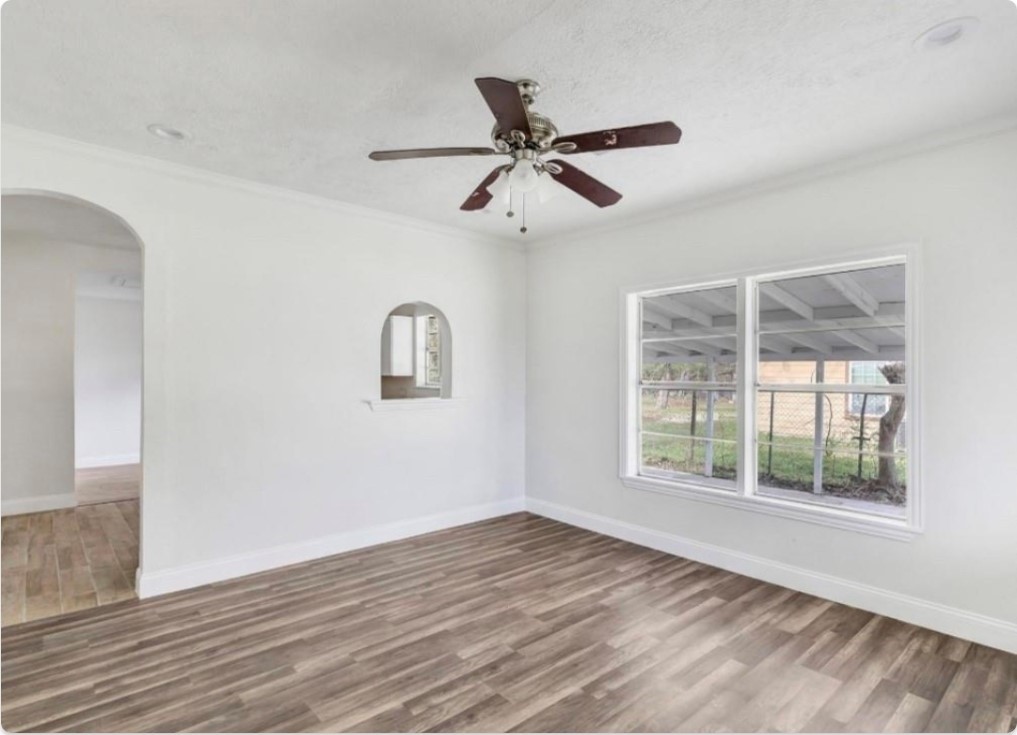 116 Trahan Street Ames, TX 77575 - Photo 3 of 23 a view of empty room with wooden floor and fan