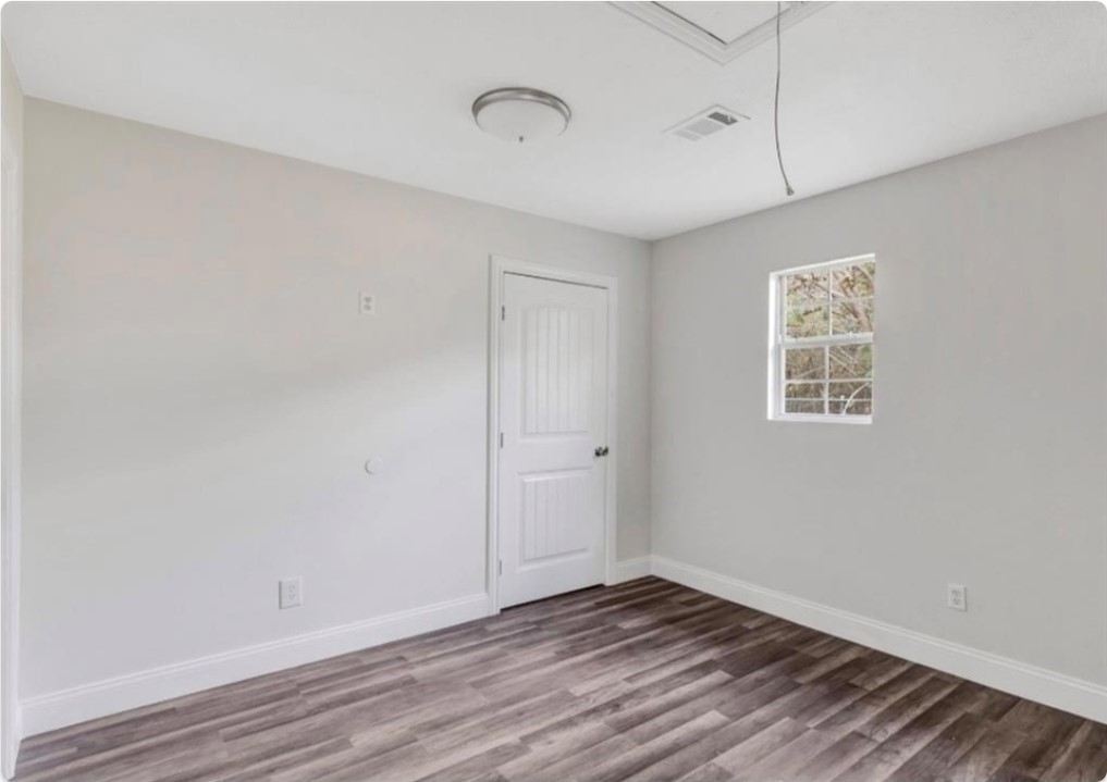 116 Trahan Street Ames, TX 77575 - Photo 10 of 23 a view of an empty room with wooden floor