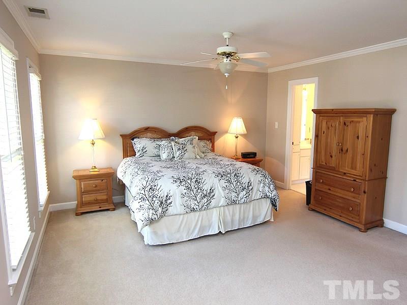 2705 Amstel Way Raleigh, NC 27613 - Photo 13 of 25 a bedroom with a bed and a chandelier