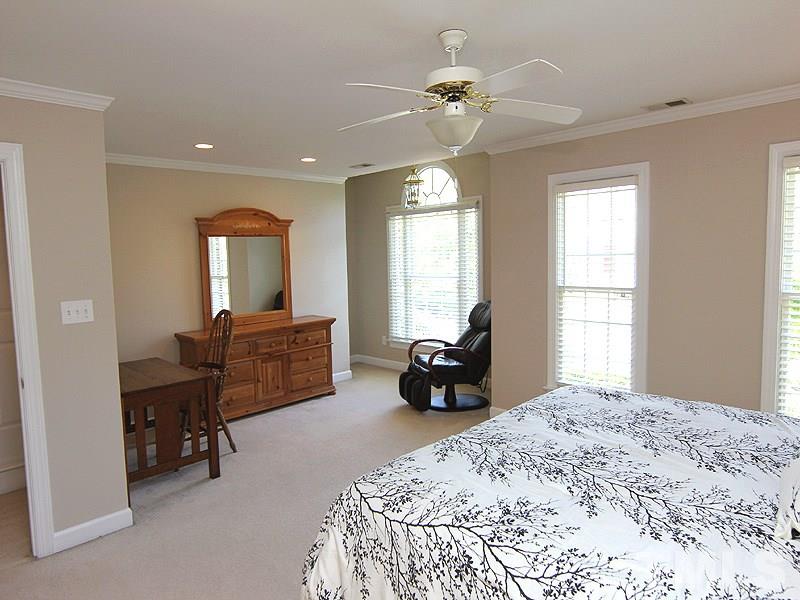 2705 Amstel Way Raleigh, NC 27613 - Photo 14 of 25 a spacious bedroom with a bed and a large window