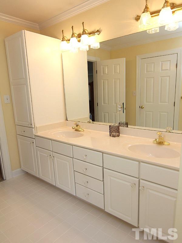 2705 Amstel Way Raleigh, NC 27613 - Photo 15 of 25 a bathroom with a double vanity sink and mirror