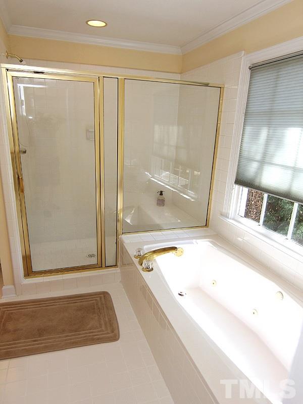 2705 Amstel Way Raleigh, NC 27613 - Photo 16 of 25 a bathroom with a tub and a shower