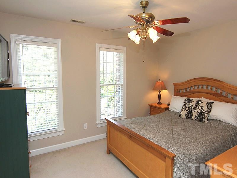 2705 Amstel Way Raleigh, NC 27613 - Photo 18 of 25 a bedroom with a bed and a chandelier