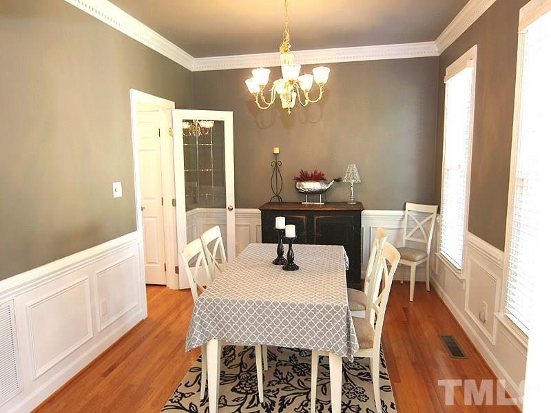 2705 Amstel Way Raleigh, NC 27613 - Photo 8 of 25 a dining room with furniture a chandelier and wooden floor