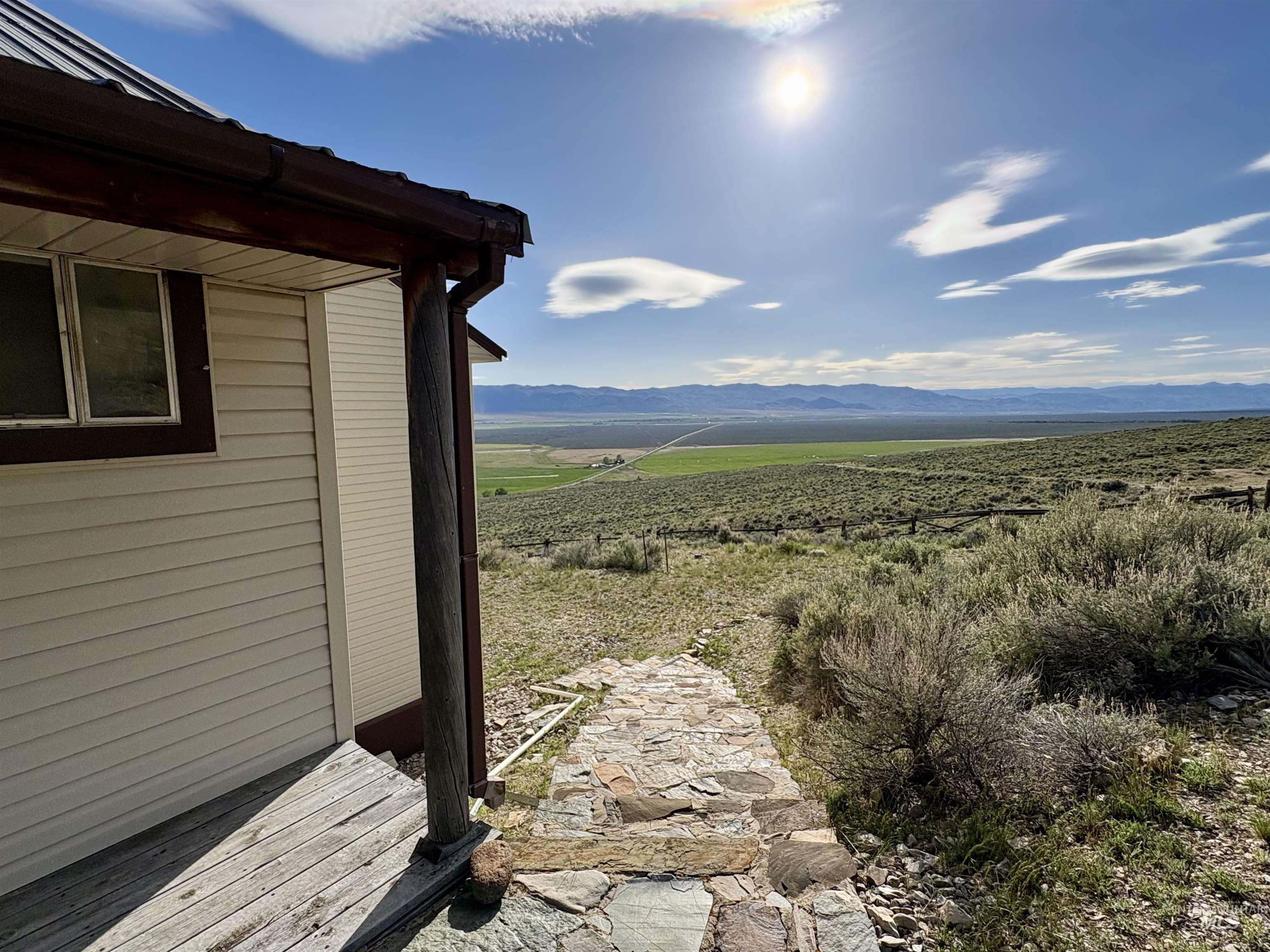 2040 Pahsimeroi River Road May, ID 83253 - Photo 23 of 29 Exterior siding with a metal roof and a stone pathway