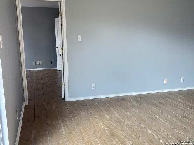 a view of a room with wooden floor