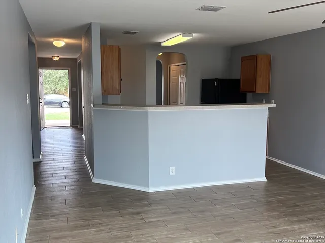 a view of a living room with wooden floor