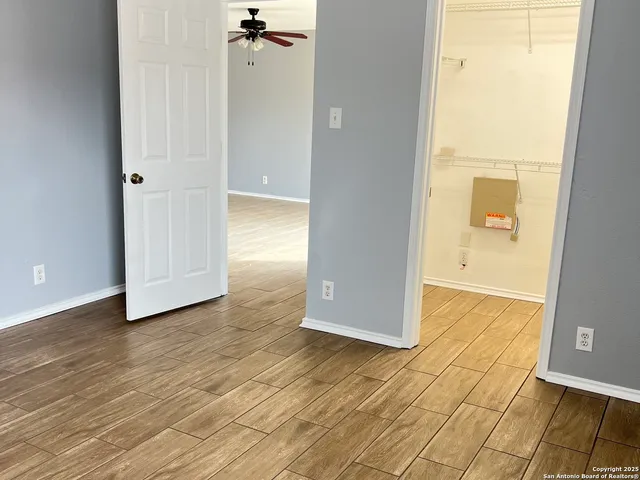 a view of a room with wooden floor