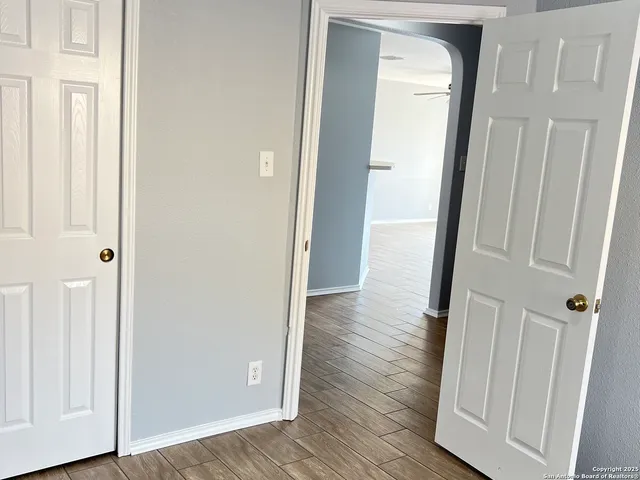 a view of a hallway with wooden floor