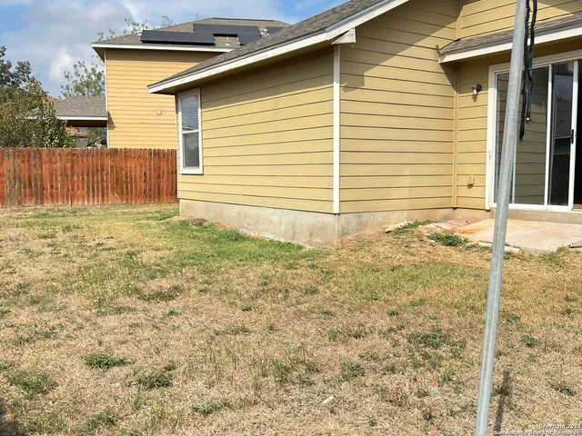 a view of a backyard of the house