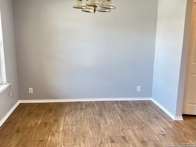 a view of a room with wooden floor