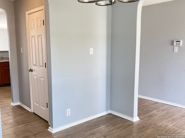 an empty room with wooden floor