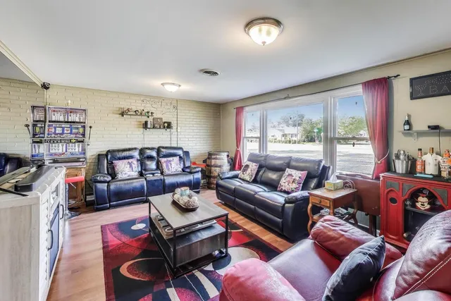 a living room with furniture a large window and a flat screen tv