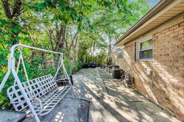 a view of a chair and table in the patio