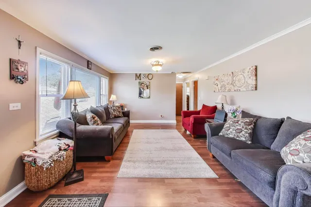 a living room with furniture and a lamp