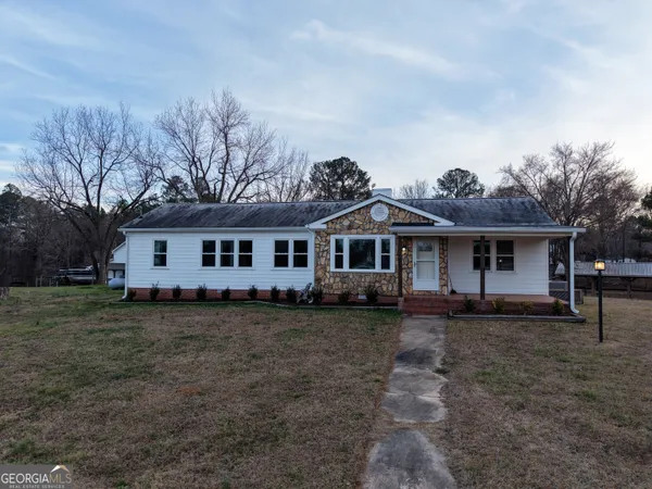 a front view of a house with a garden
