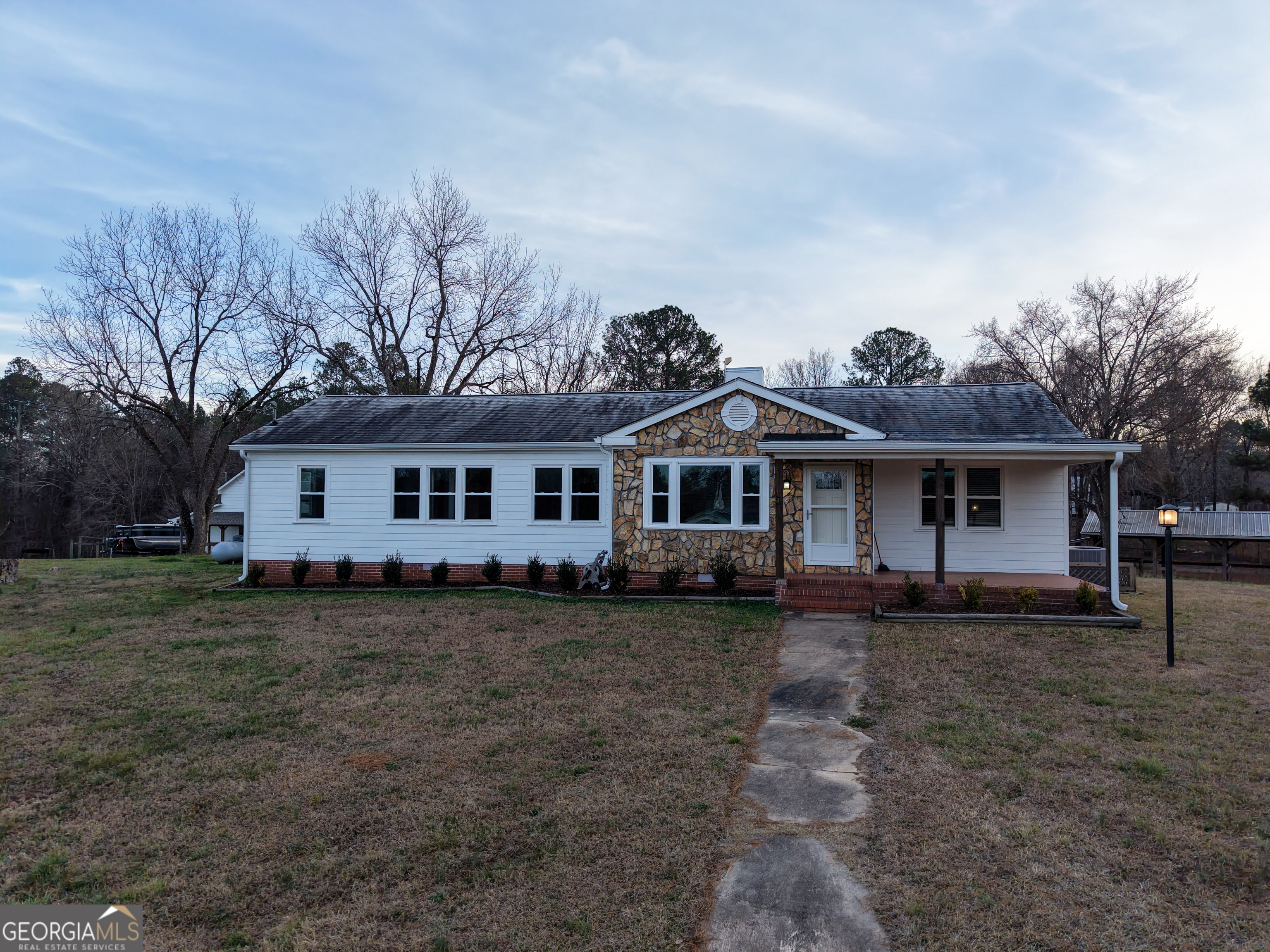 a front view of a house with a garden
