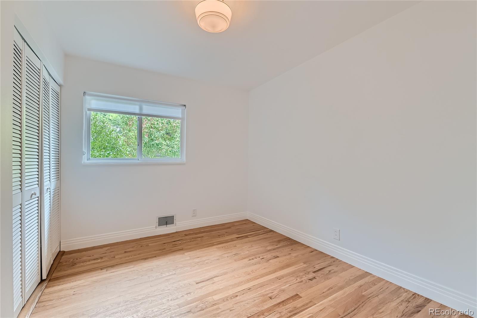 265 30th Street Boulder, CO 80305 - Photo 21 of 25 an empty room with wooden floor and windows