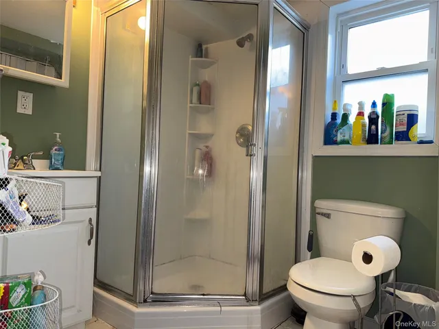 a bathroom with a toilet and a shower