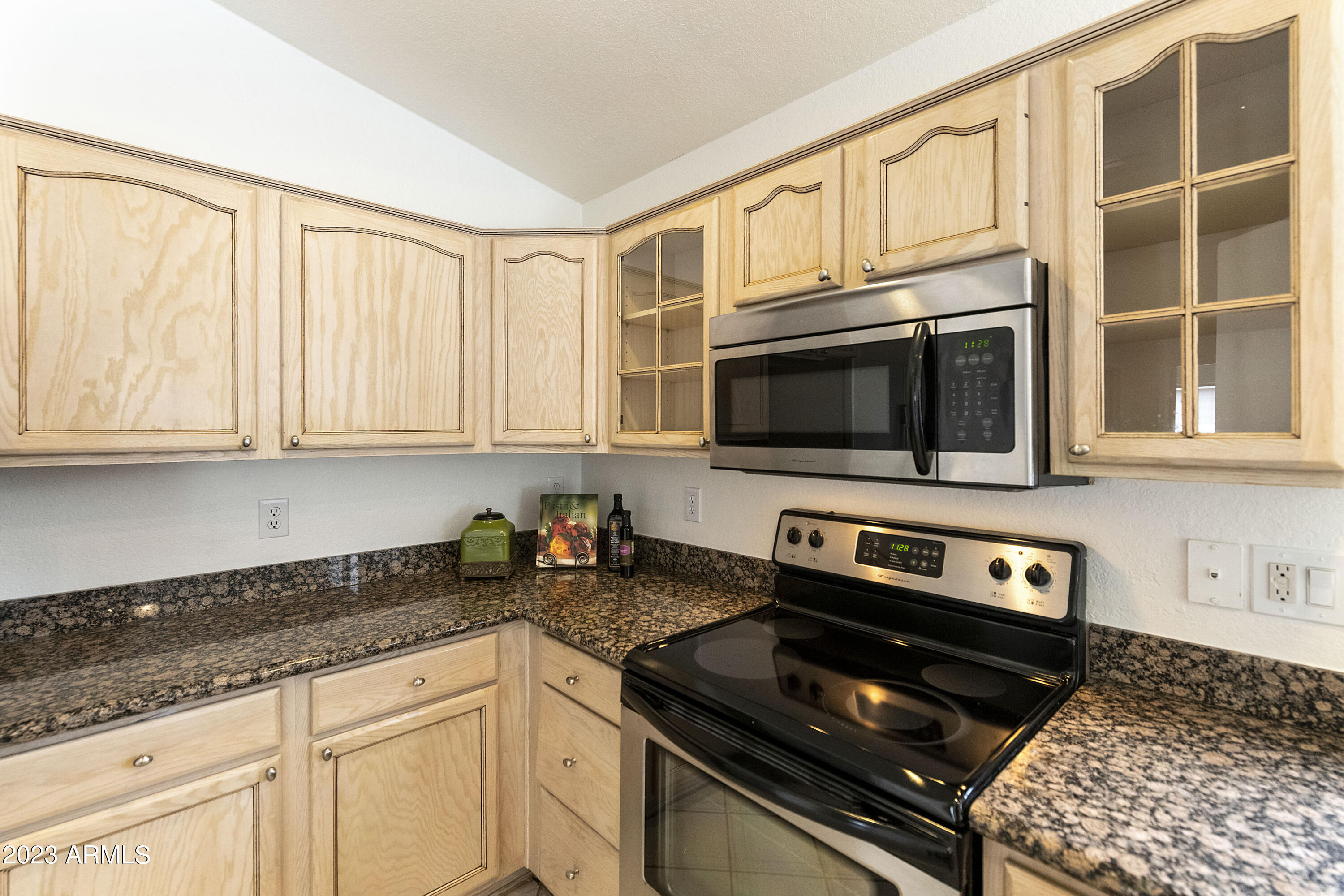 167 West Smoke Tree Road Gilbert, AZ 85233 - Photo 10 of 31 a kitchen with stainless steel appliances granite countertop a stove and a microwave