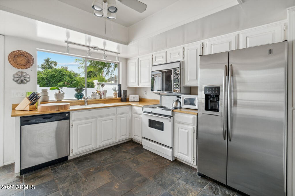 525 East Calavar Road Phoenix, AZ 85022 - Photo 11 of 25 a kitchen with a refrigerator and a sink