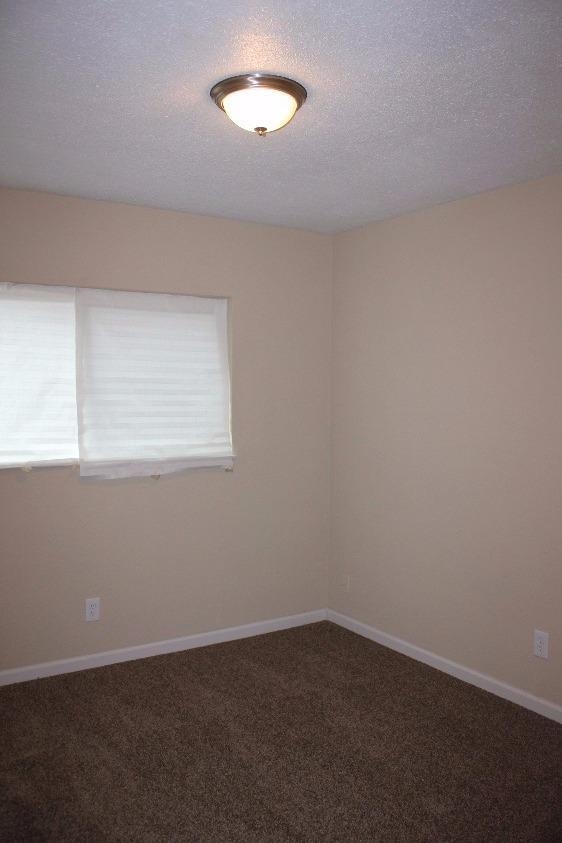 1133 D Street Reedley, CA 93654 - Photo 10 of 10 an empty room with a window