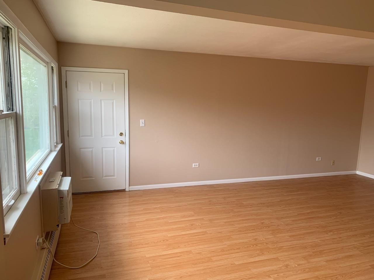 239 Northway Park Road Machesney Park, IL 61115 - Photo 3 of 15 a view of an empty room with wooden floor and a window