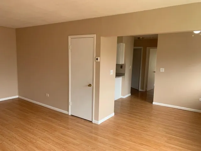 a kitchen with a sink a refrigerator and cabinets