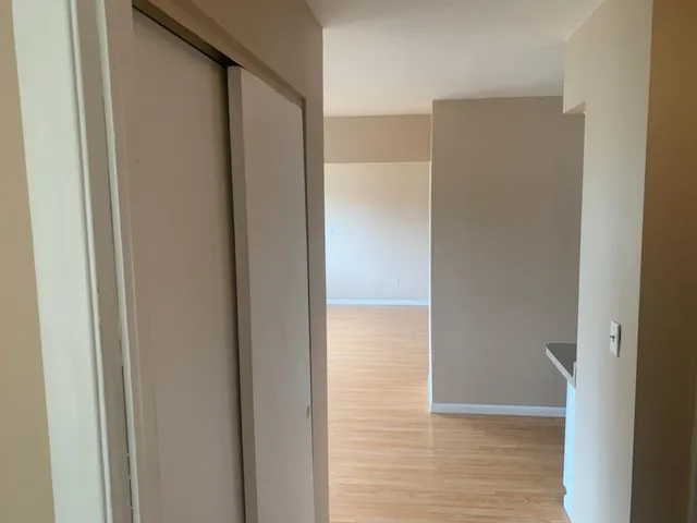 a view of hallway with wooden floor