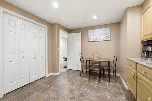 5196 Rodeo Circle Oakley, UT 84055 - Photo 39 of 57 Spacious room featuring neutral wall tones, square tile flooring, white bi-fold closet doors, and recessed lighting