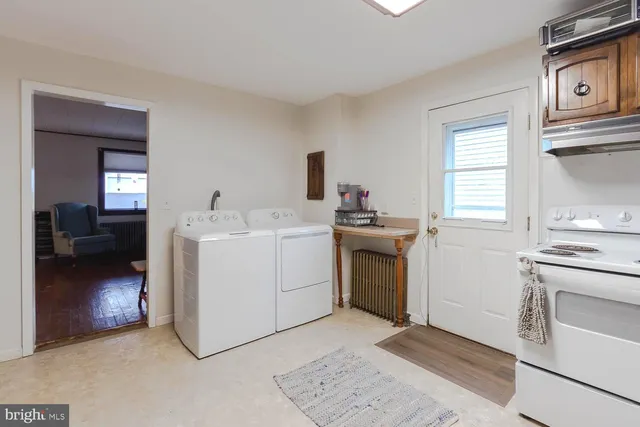 a utility room with sink dryer and washer