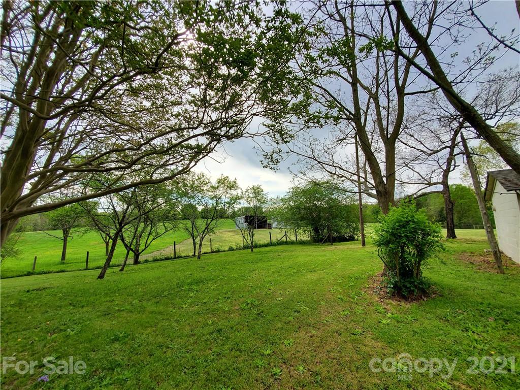 16.104 Ruben Road, Unit 2713 Monroe, NC 28112 - Photo 13 of 15 a view of grassy field with benches