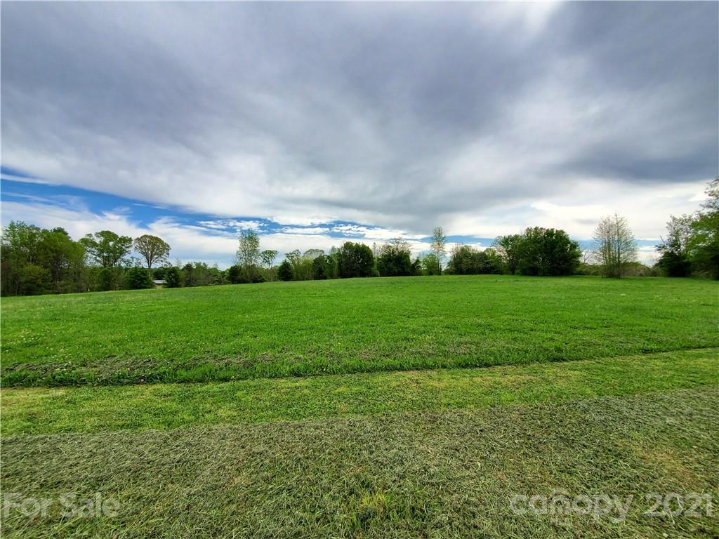 16.104 Ruben Road, Unit 2713 Monroe, NC 28112 - Photo 3 of 15 a view of a green field with clear sky