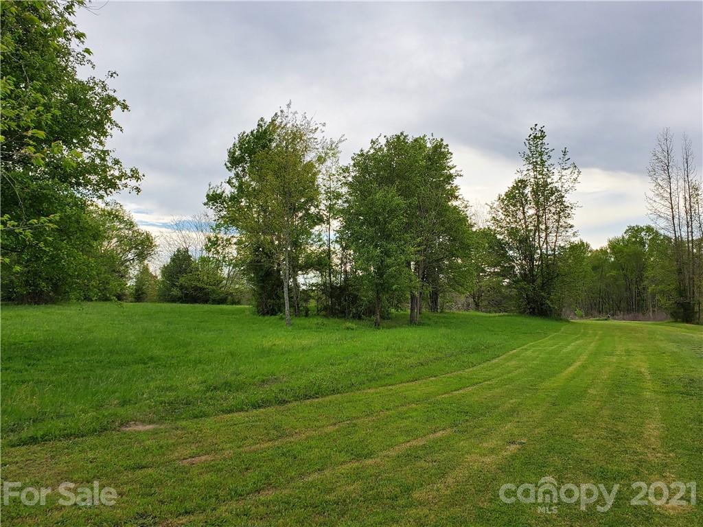 16.104 Ruben Road, Unit 2713 Monroe, NC 28112 - Photo 8 of 15 a view of a grassy field with trees