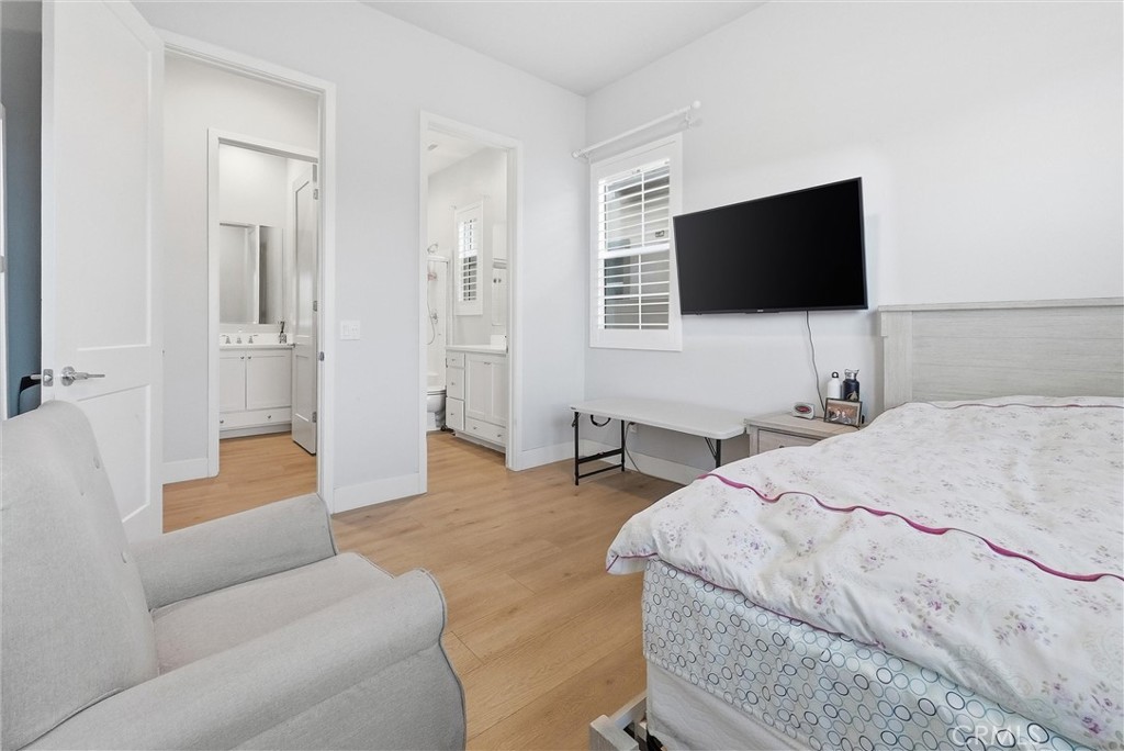 15828 Kingston Road Chino Hills, CA 91709 - Photo 13 of 33 a bedroom with a bed and a flat screen tv