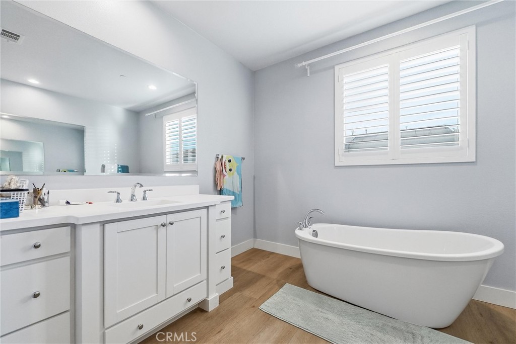 15828 Kingston Road Chino Hills, CA 91709 - Photo 18 of 33 a bathroom with a sink a toilet a mirror and a window