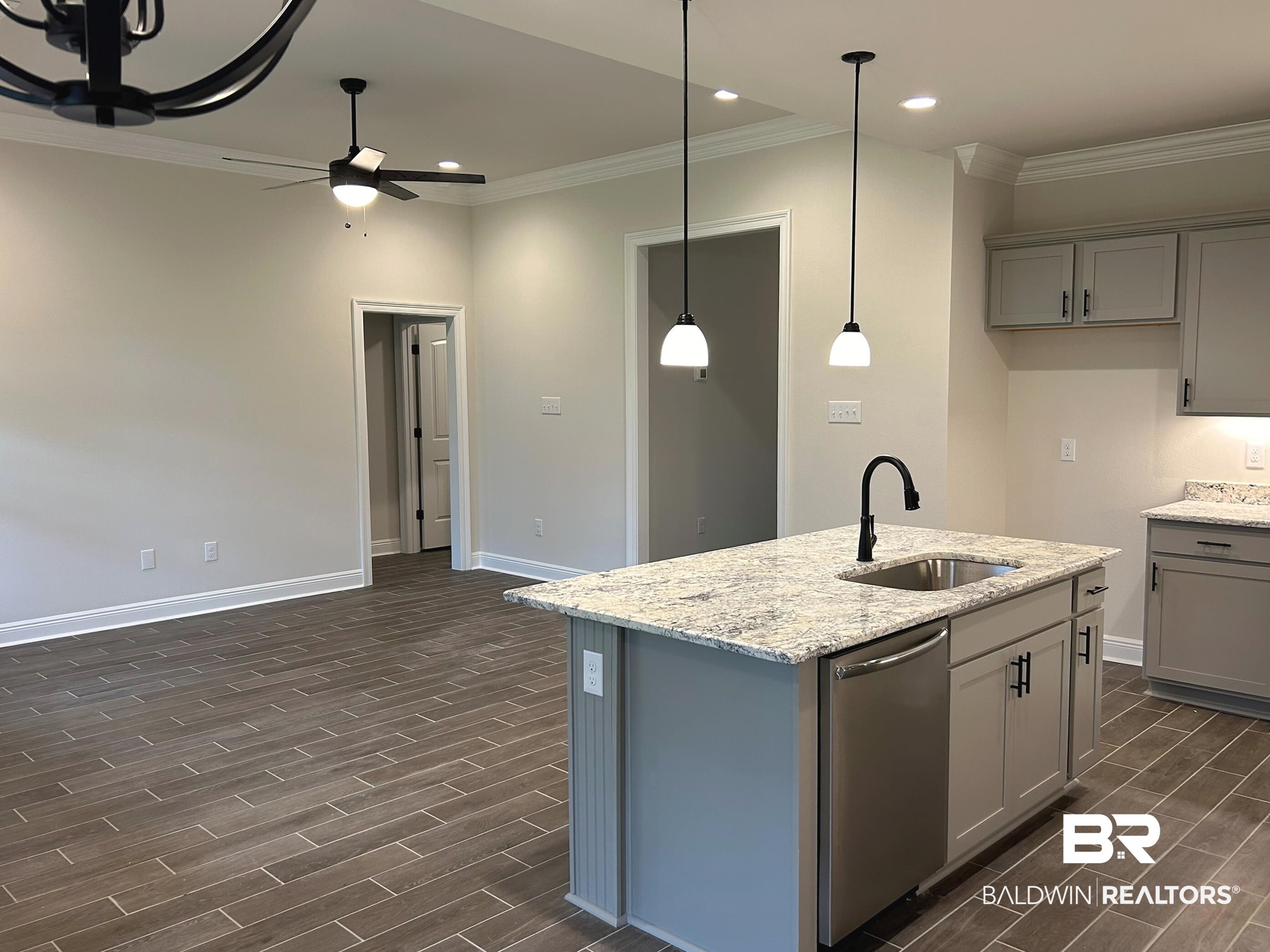 844 Sumter Loop Foley, AL 36535 - Photo 4 of 18 Kitchen with stainless steel dishwasher, dark hardwood / wood-style flooring, ceiling fan, and sink