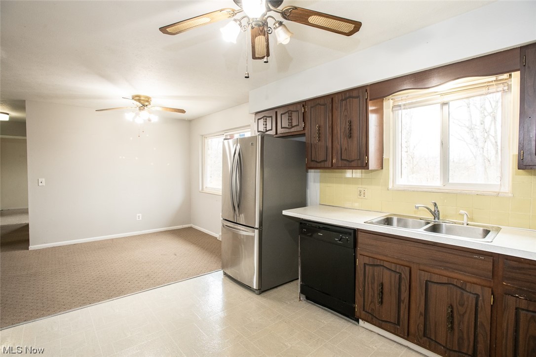 14358 Prospect Road Strongsville, OH 44149 - Photo 11 of 35 Kitchen with plenty of natural light, black dishwasher, sink, and light carpet