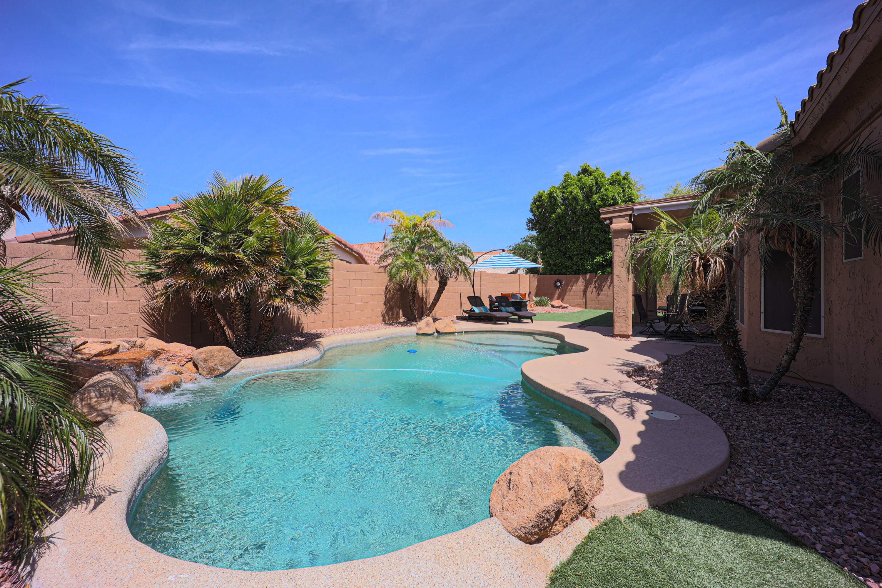 464 East Ranch Road Gilbert, AZ 85296 - Photo 4 of 21 a view of a backyard with table and chairs potted plants and palm tree