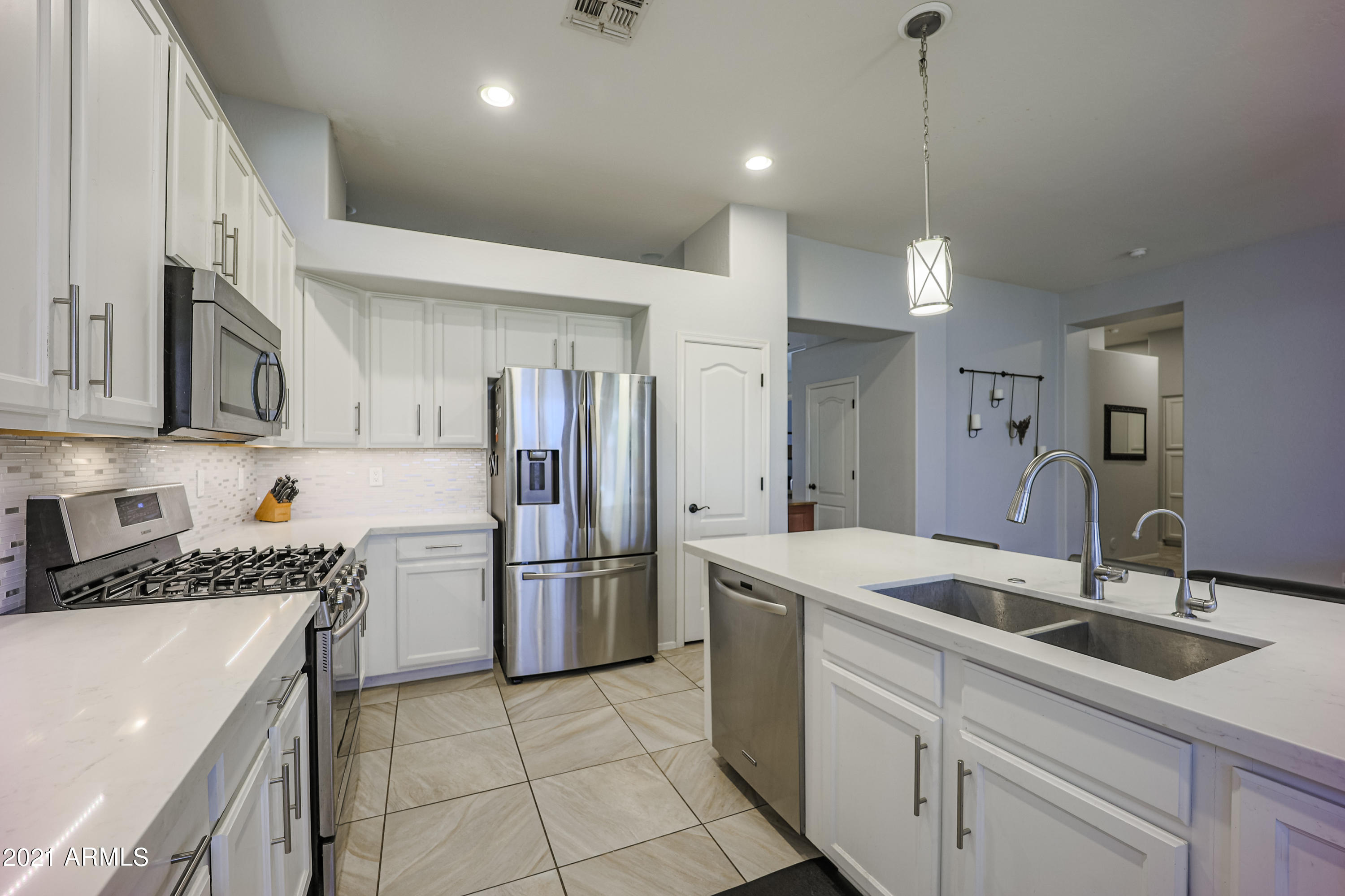 464 East Ranch Road Gilbert, AZ 85296 - Photo 8 of 21 a kitchen that has a sink cabinets and stainless steel appliances